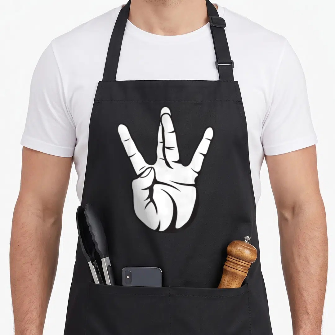 Westside hip apron - Black and white line art of a hand showing three extended fingers — shown on a black cotton canvas apron against a white background