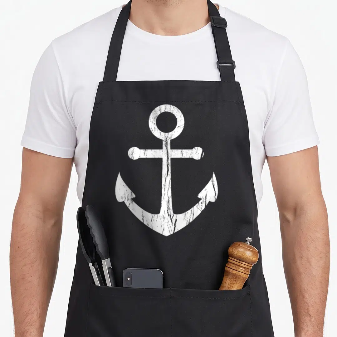 Boat nautical apron - Single white anchor with distressed weathered texture on grey background — shown on a black cotton canvas apron against a white background