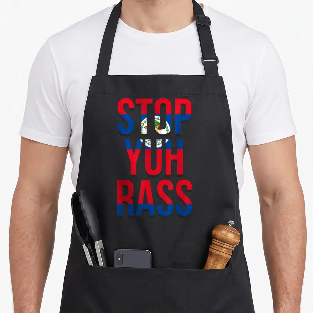 Stop pride apron - STOP YUH RASS text filled with Belizean flag red blue white and national emblem — shown on a black cotton canvas apron against a white background