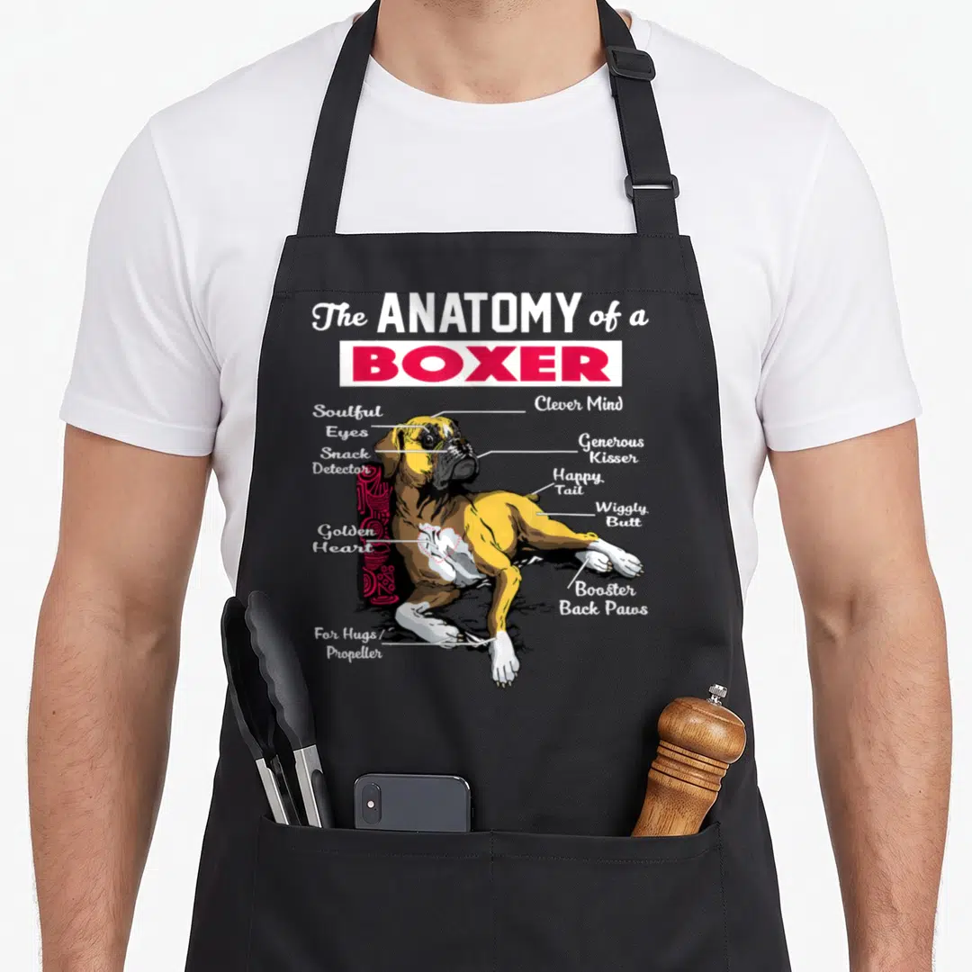 Anatomy boxer dog apron - Cartoon boxer diagram with labels like snack detector and wiggly butt connected by white lines — shown on a black cotton canvas apron against a white background