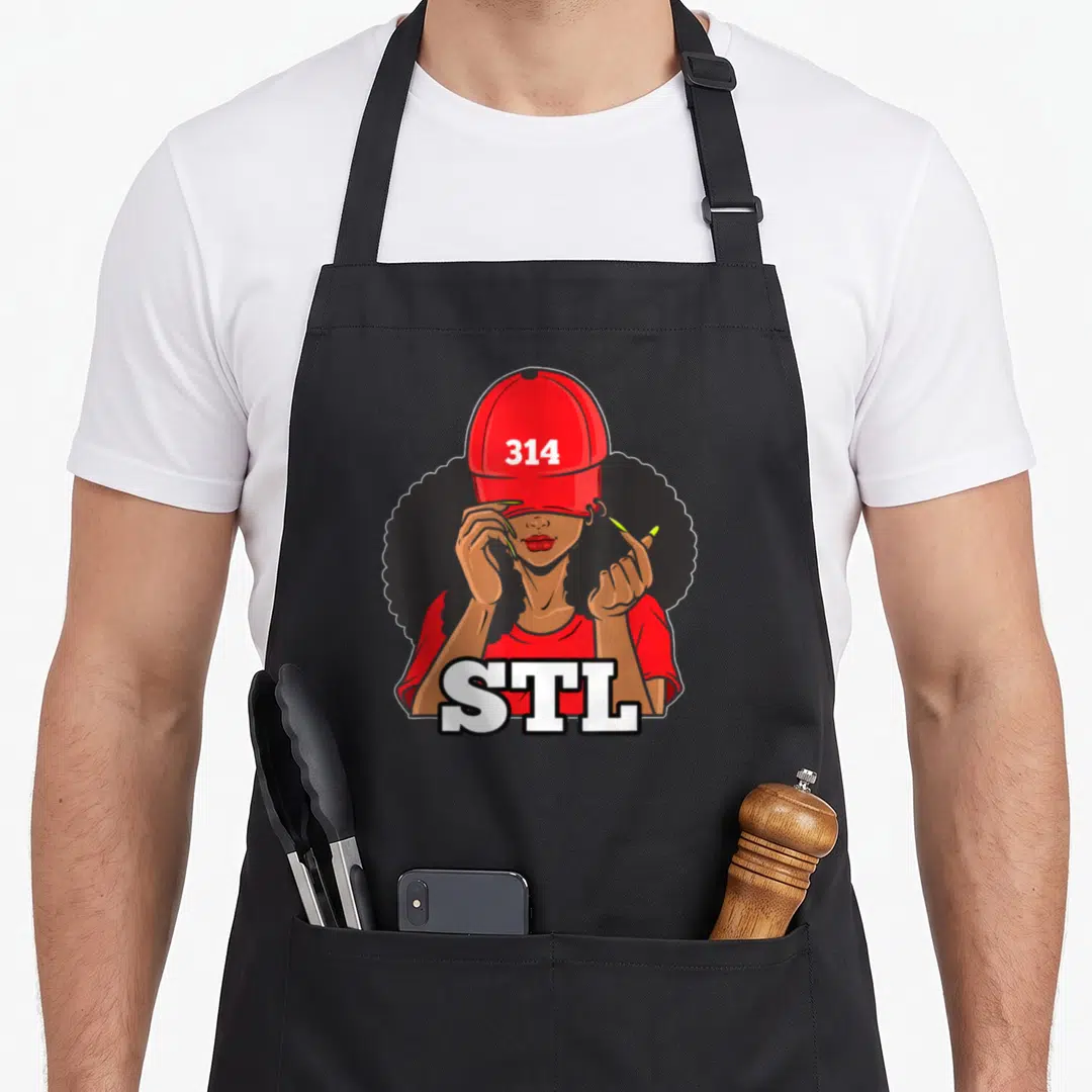 Stl saint louis apron - Cartoon woman in red cap with 314 and large STL text across bottom — shown on a black cotton canvas apron against a white background