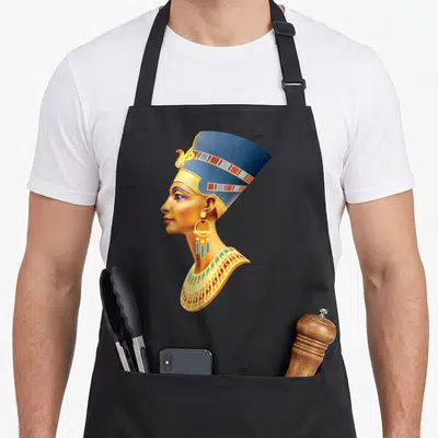 Queen egyptian apron - Realistic profile of an Egyptian woman wearing a blue crown and gold collar facing left — shown on a black cotton canvas apron against a white background