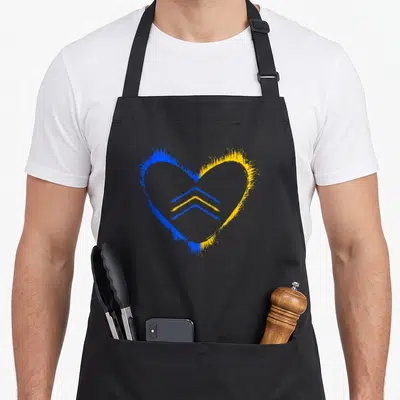 Trisonomy an extra apron - Blue and yellow watercolor heart with two stacked chevrons representing Down Syndrome support — shown on a black cotton canvas apron against a white background