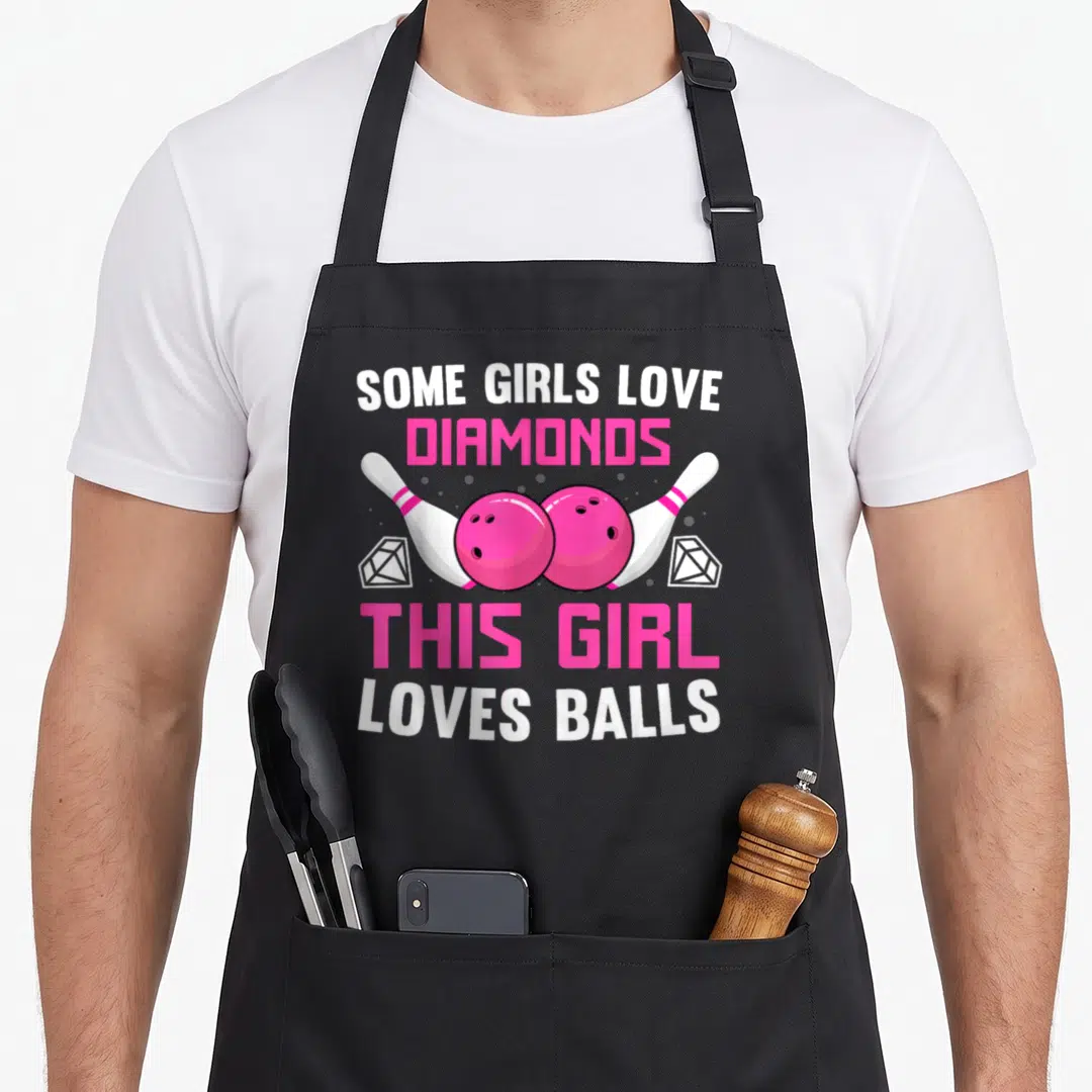 Bowling track apron - Pink bowling balls, pins, and diamonds with white and pink text reading Some Girls Love Diamonds — shown on a black cotton canvas apron against a white background
