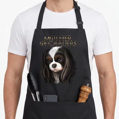 Charle spaniel king apron - Realistic Cavalier King Charles Spaniel head with stacked gold Mother of Cavaliers text — shown on a black cotton canvas apron against a white background