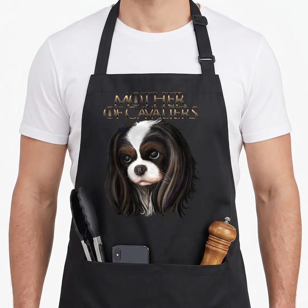 Charle spaniel king apron - Realistic Cavalier King Charles Spaniel head with stacked gold Mother of Cavaliers text — shown on a black cotton canvas apron against a white background