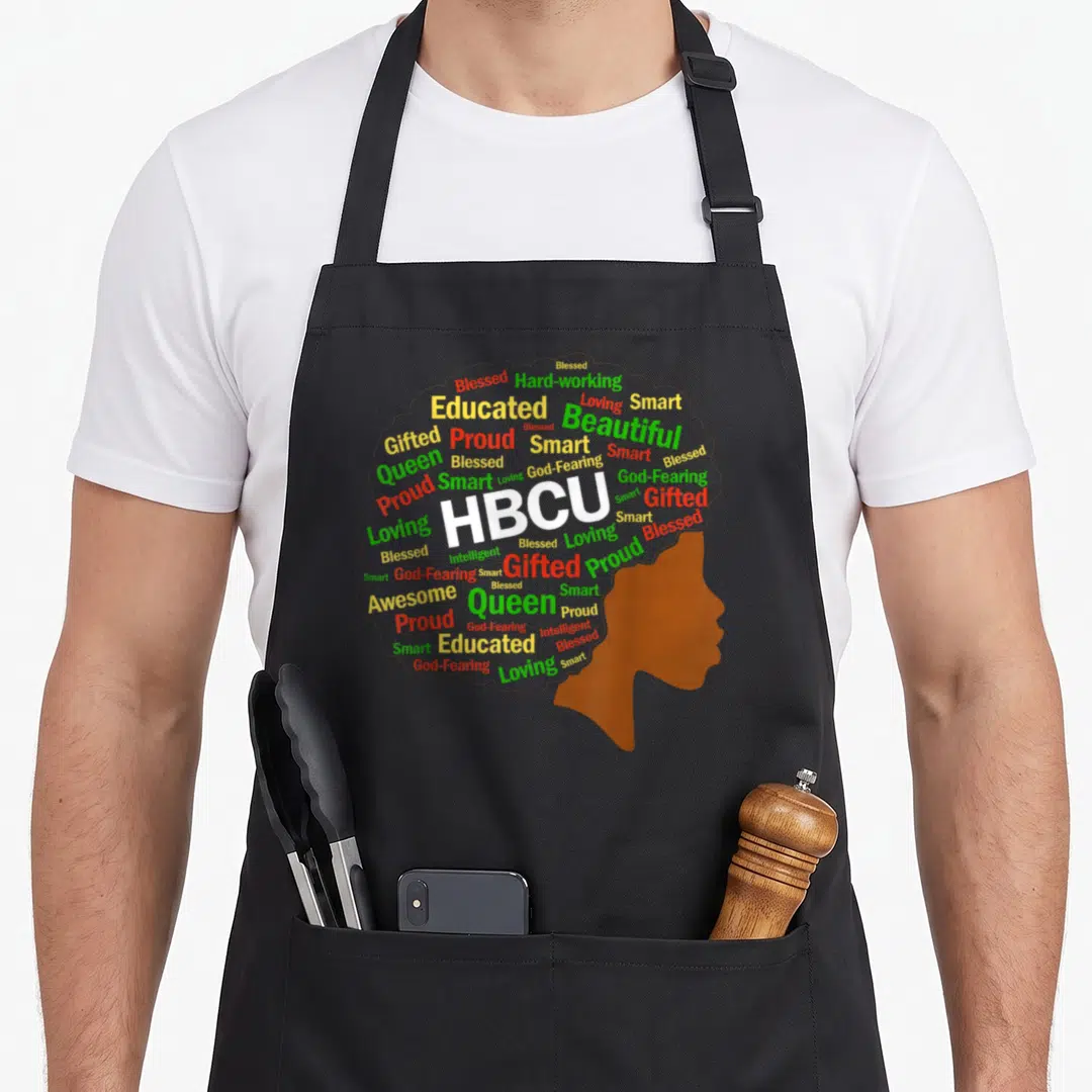 Grad historical aprons - Brown female profile silhouette filled with word cloud containing HBCU, educated, blessed — shown on a black cotton canvas apron against a white background