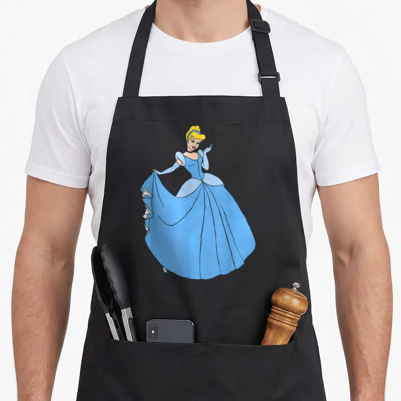Princess cinderella apron - Cartoon Cinderella in blue dress holding skirt on black bib apron — shown on a black cotton canvas apron against a white background
