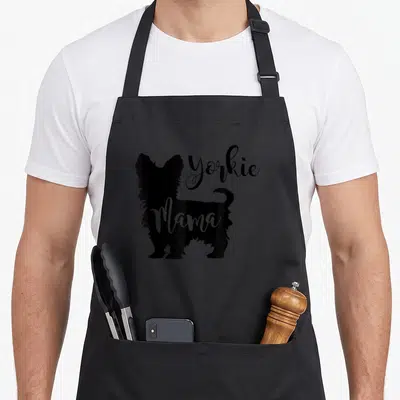 Profile yorkie apron - Black Yorkshire Terrier silhouette with white Mama text overlay — shown on a black cotton canvas apron against a white background