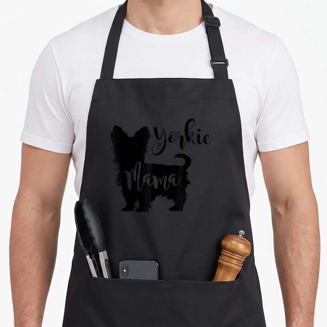Profile yorkie apron - Black Yorkshire Terrier silhouette with white Mama text overlay — shown on a black cotton canvas apron against a white background