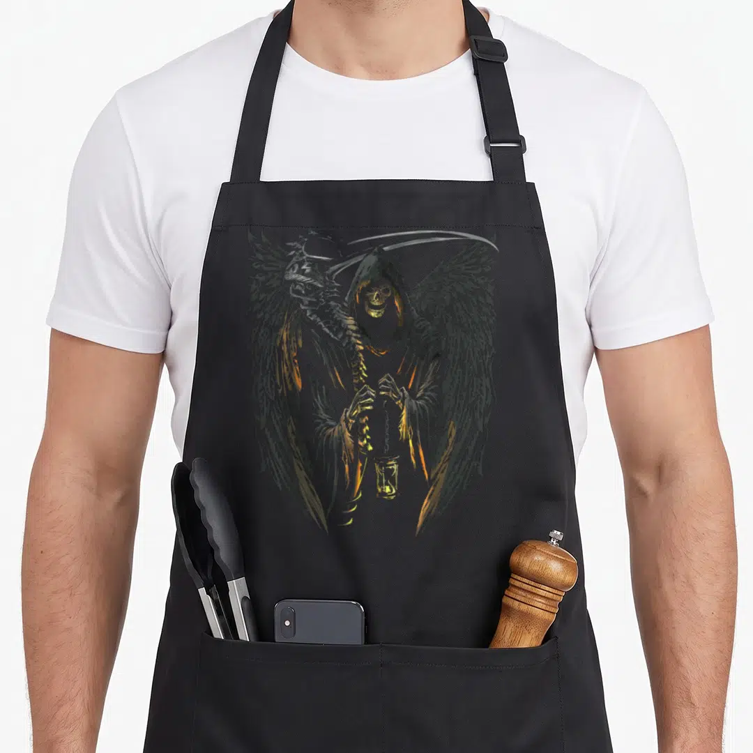 Death angels in aprons - Winged skeletal figure in grey and gold holding a lantern and scythe behind its head — shown on a black cotton canvas apron against a white background
