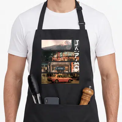 Vaporwave japan apron - Four stacked photo panels of Japanese cityscapes with vertical white text overlay — shown on a black cotton canvas apron against a white background