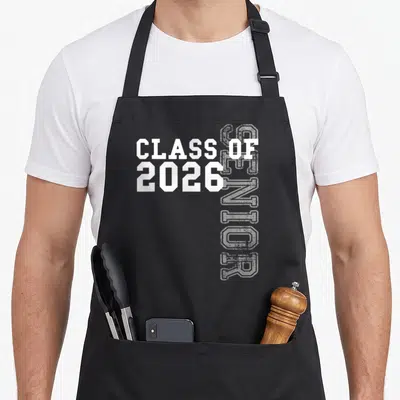 Class student aprons - White Class of 2026 text and vertical grey Senior outline on black fabric — shown on a black cotton canvas apron against a white background