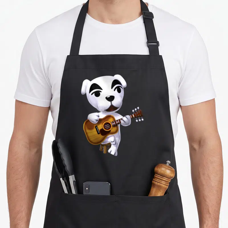 Slider crossover apron - White cartoon dog sitting on stool playing brown acoustic guitar — shown on a black cotton canvas apron against a white background