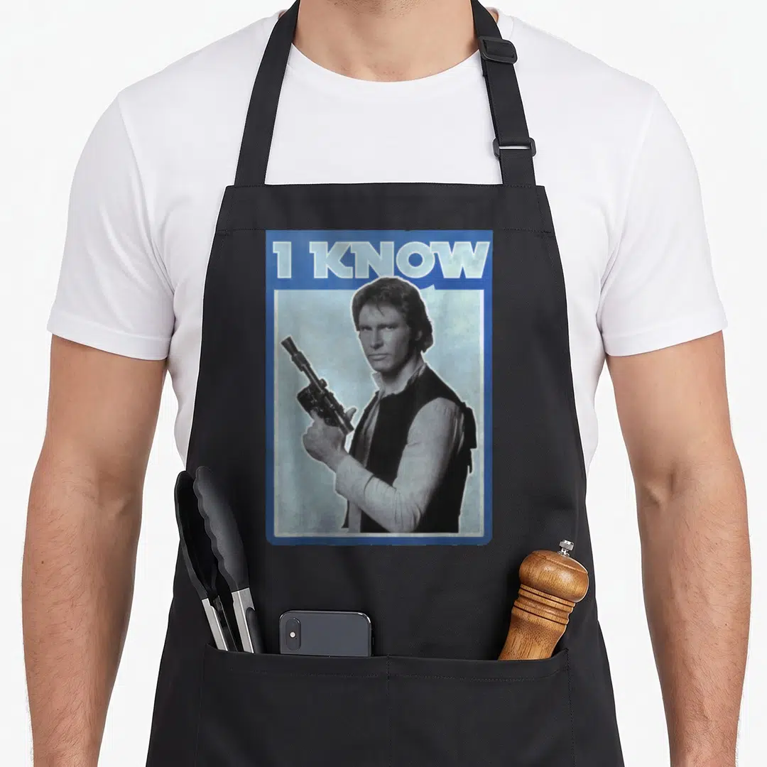 Unscripted iconic aprons - Retro blue poster with I KNOW text and man holding blaster — shown on a black cotton canvas apron against a white background