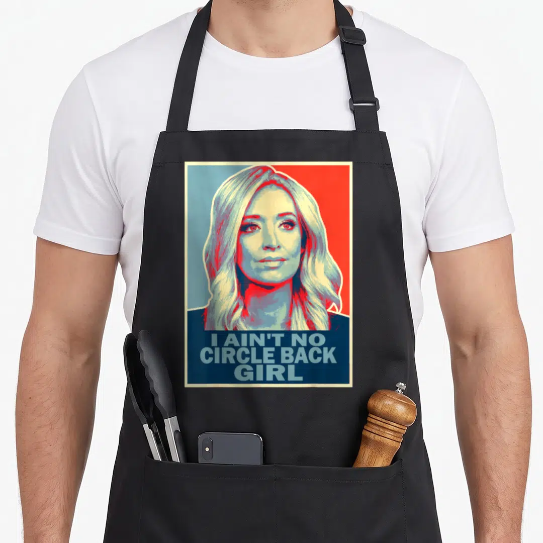 Circle secretary apron - Retro portrait woman I AIN'T NO CIRCLE BACK GIRL text red blue cream — shown on a black cotton canvas apron against a white background