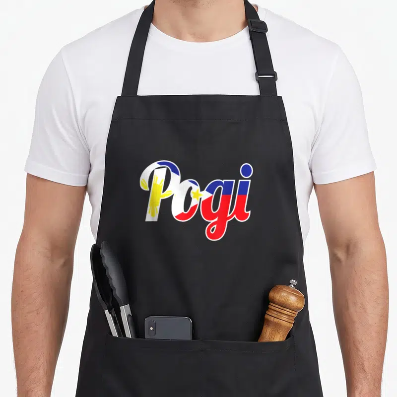 Pogi pride apron - Pogi text filled with Philippine flag blue red white yellow sun and stars — shown on a black cotton canvas apron against a white background