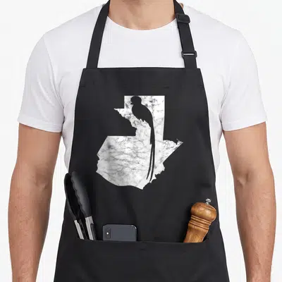 Chapin guatemala apron - White textured map of Guatemala containing a dark grey quetzal bird silhouette — shown on a black cotton canvas apron against a white background
