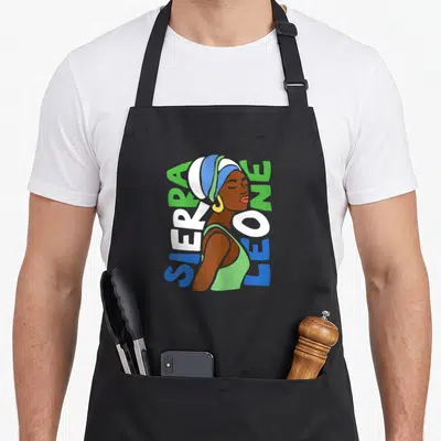 Leone african apron - Cartoon woman profile with vertical SIERRA LEONE text in green, white, blue — shown on a black cotton canvas apron against a white background