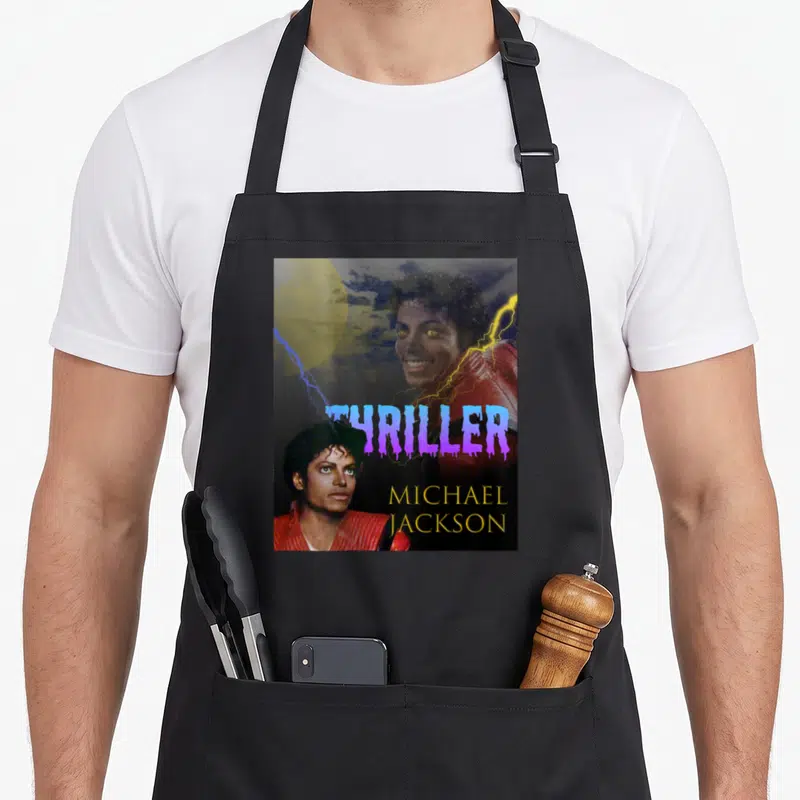 Jackson thriller michaels apron - Michael Jackson portrait with purple dripping Thriller text, yellow name — shown on a black cotton canvas apron against a white background