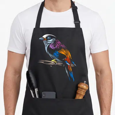 Tribal bird apron - Stylized bird perched on branch with blue purple orange red and brown geometric patterns — shown on a black cotton canvas apron against a white background