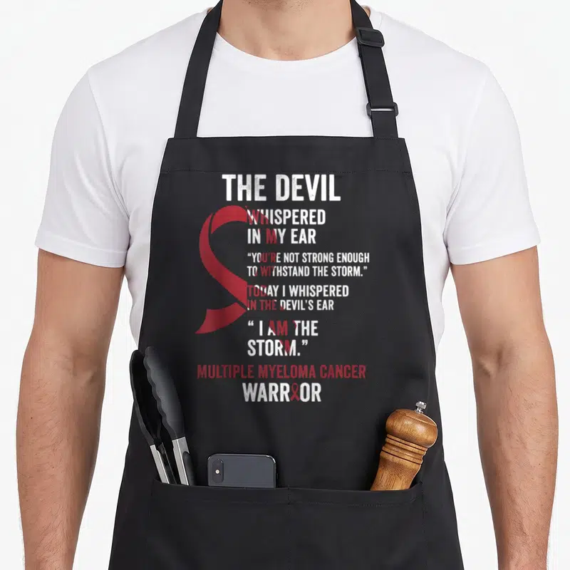 Multiple devil's apron - Red awareness ribbon and white distressed text reading I AM THE STORM for Multiple Myeloma — shown on a black cotton canvas apron against a white background