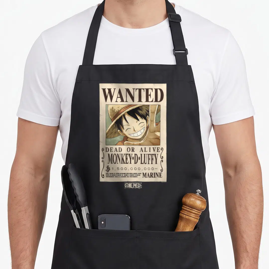 Luffy anime apron - Wanted poster with Monkey D Luffy portrait, 1.5 billion bounty, and Japanese disclaimer text — shown on a black cotton canvas apron against a white background