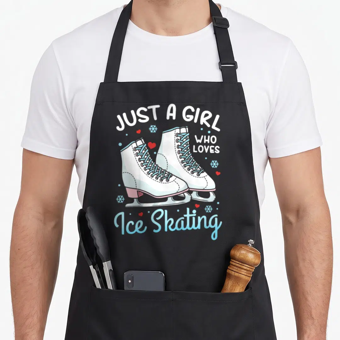Skating boys ice apron - White figure skates with blue laces and red hearts under arched text reading Just A Girl Who — shown on a black cotton canvas apron against a white background