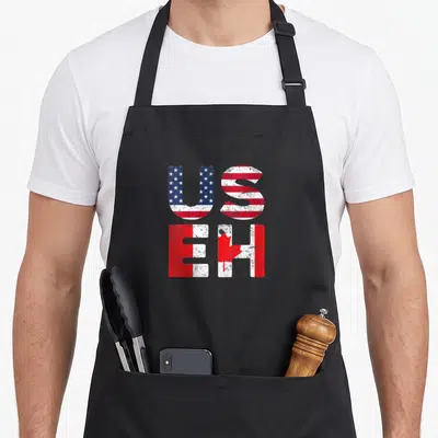 Flag useh pride apron - Stacked US and EH letters filled with USA and Canada flag patterns in distressed red white blue — shown on a black cotton canvas apron against a white background