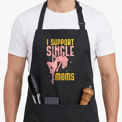 Funny support single mom apron - Woman on pole surrounded by stars with I SUPPORT SINGLE MOMS text in yellow and pink — shown on a black cotton canvas apron against a white background