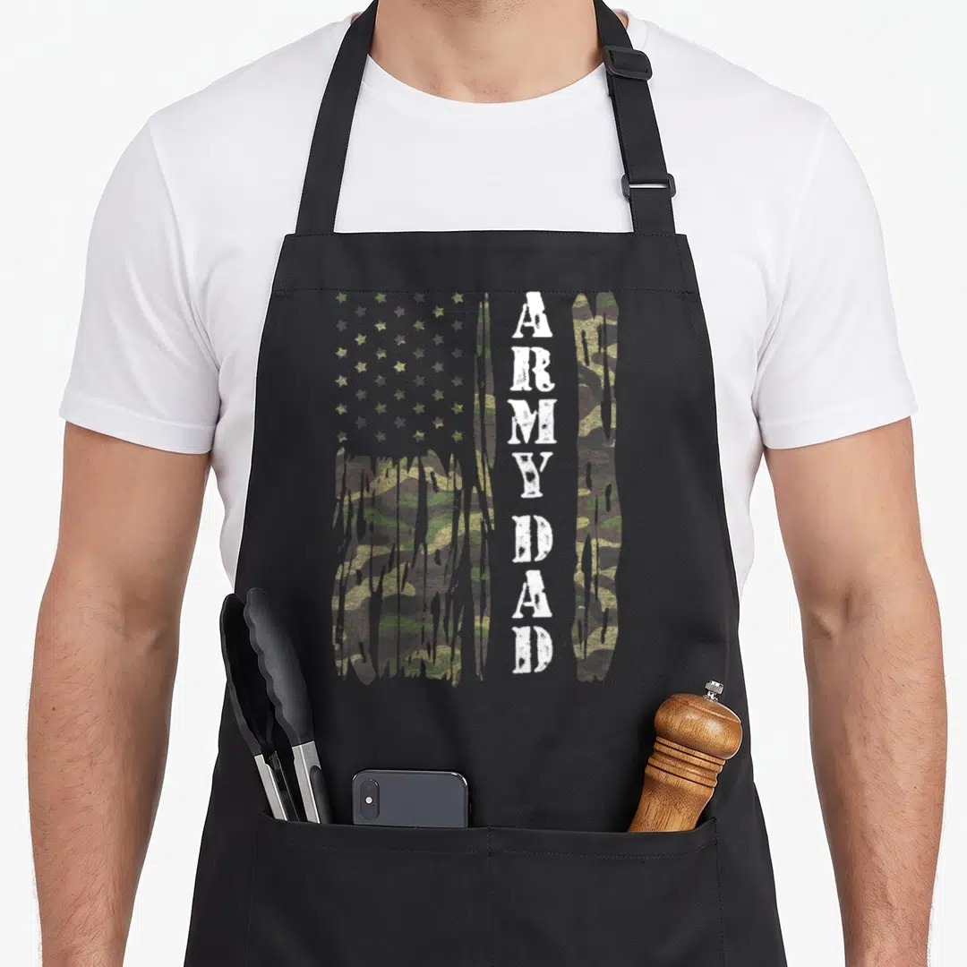 Flag army father day apron - Distressed camo USA flag with dripping edges and vertical white ARMY DAD text — shown on a black cotton canvas apron against a white background