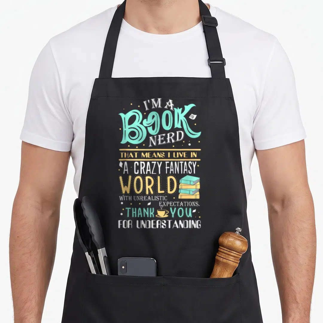 Bookish nerd apron - Stacked books and coffee cup beside fantasy world typography in teal and yellow — shown on a black cotton canvas apron against a white background