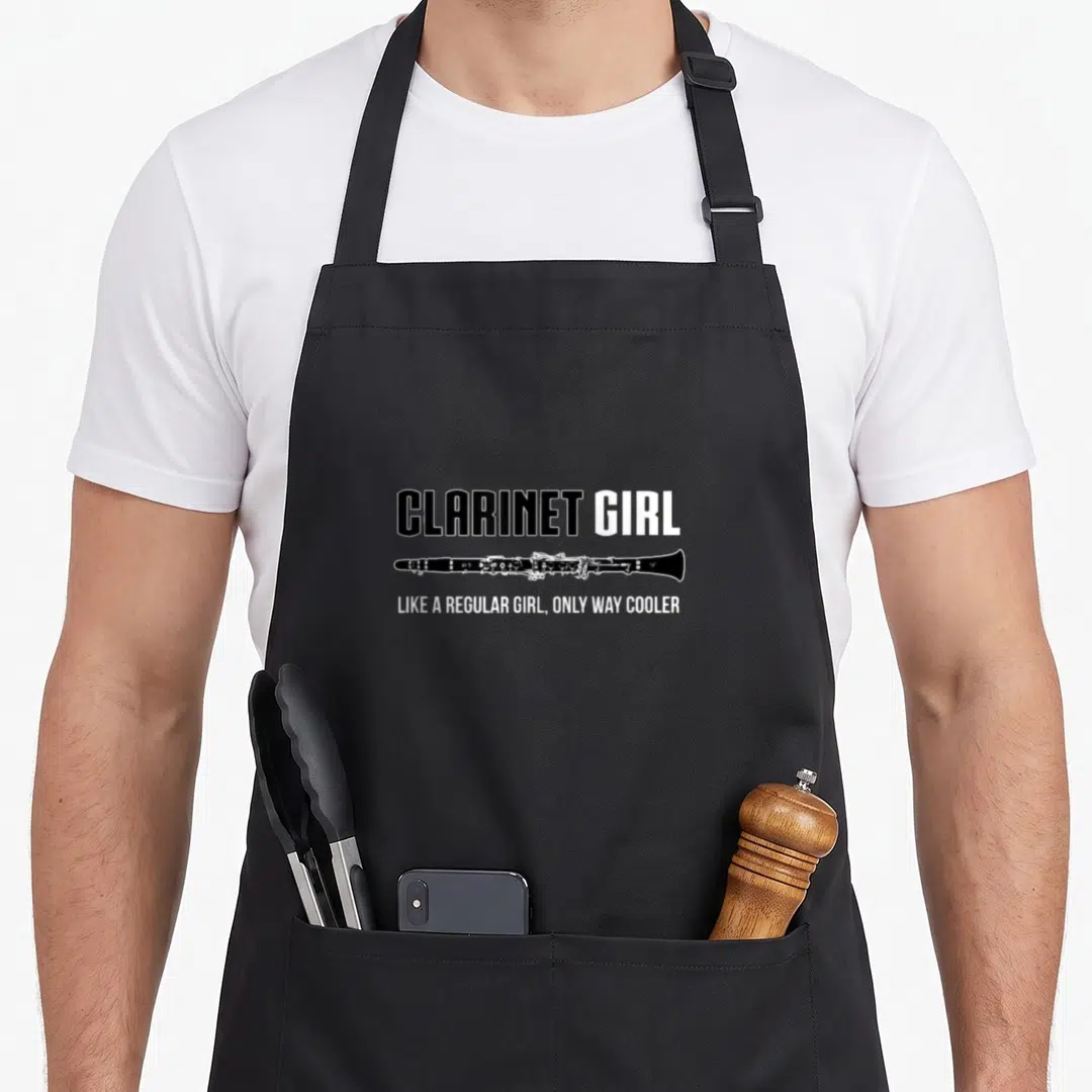 Band clarinet apron - CLARINET GIRL text above black clarinet silhouette with slogan below — shown on a black cotton canvas apron against a white background