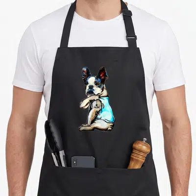 Boston mother's day aprons - Realistic dog in blue shirt with I love mom text on leg — shown on a black cotton canvas apron against a white background