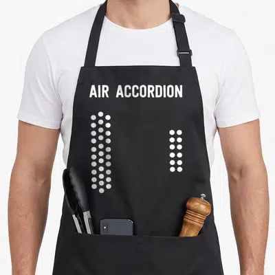 Vintage air accordion apron - White text AIR ACCORDION above two vertical columns of white dots — shown on a black cotton canvas apron against a white background