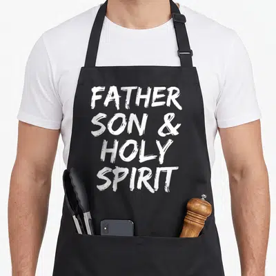 Christian father son apron - White stacked text reading FATHER SON & HOLY SPIRIT on grey background — shown on a black cotton canvas apron against a white background