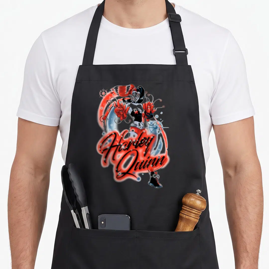 Airbrush vehicle apron - Cartoon Harley Quinn holding red firecrackers with script text in red and black — shown on a black cotton canvas apron against a white background