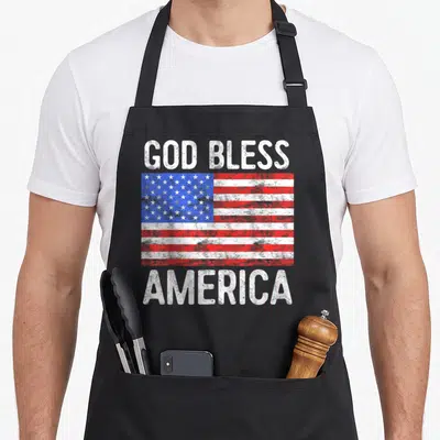 God fourth of july aprons - Distressed US flag with God Bless America text in red white blue — shown on a black cotton canvas apron against a white background