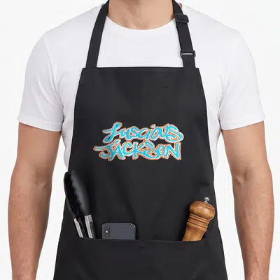 Luscious jackson mississippi apron - Stacked light blue and orange graffiti text reading Luscious Jackson with white — shown on a black cotton canvas apron against a white background
