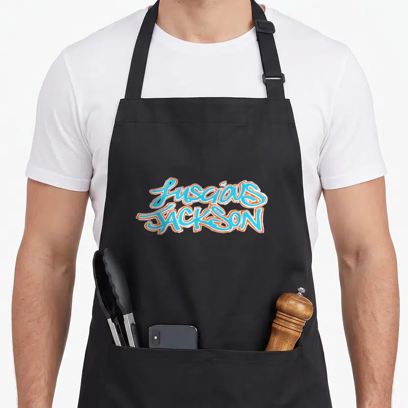 Luscious jackson mississippi apron - Stacked light blue and orange graffiti text reading Luscious Jackson with white — shown on a black cotton canvas apron against a white background