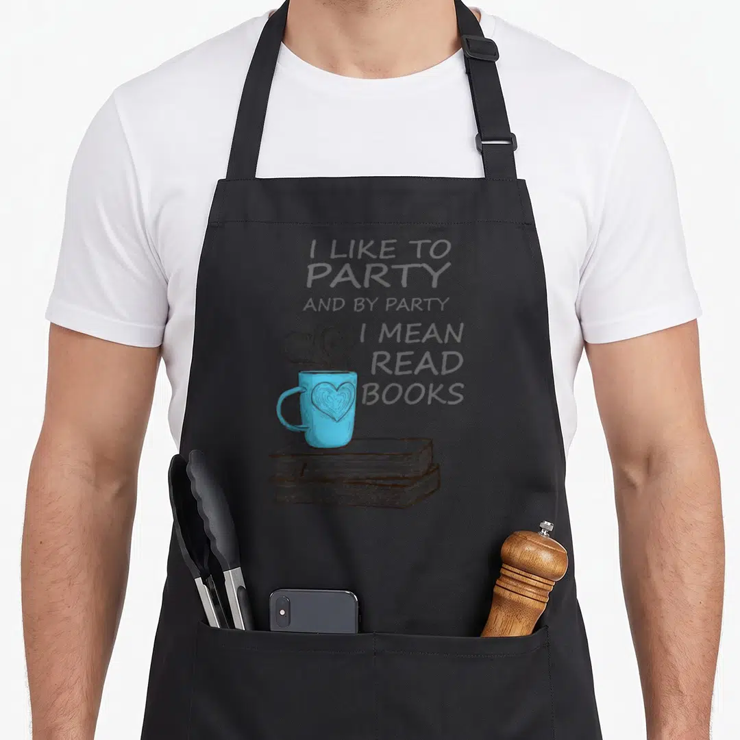 Mean book apron - Blue mug with heart on two stacked books with steam and quote text — shown on a black cotton canvas apron against a white background