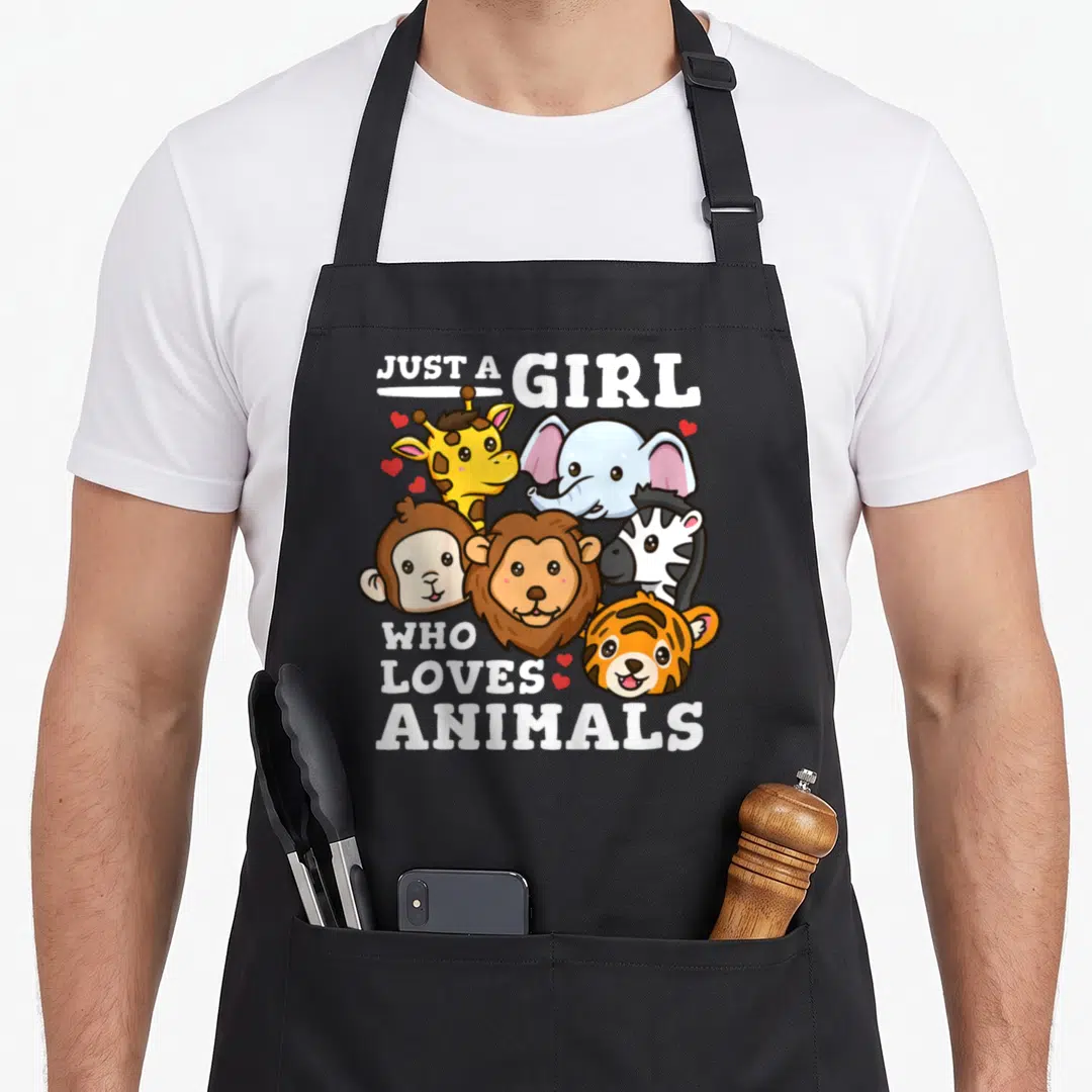 Elephant animal apron - Cartoon elephant giraffe lion zebra tiger monkey heads with Just a Girl Who Loves Animals text — shown on a black cotton canvas apron against a white background