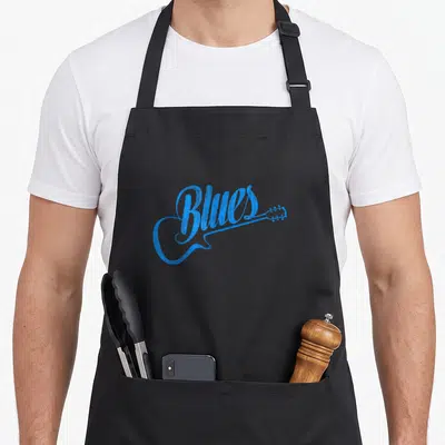 Blue music apron - Distressed blue guitar shape formed by the word Blues with neck extending right — shown on a black cotton canvas apron against a white background