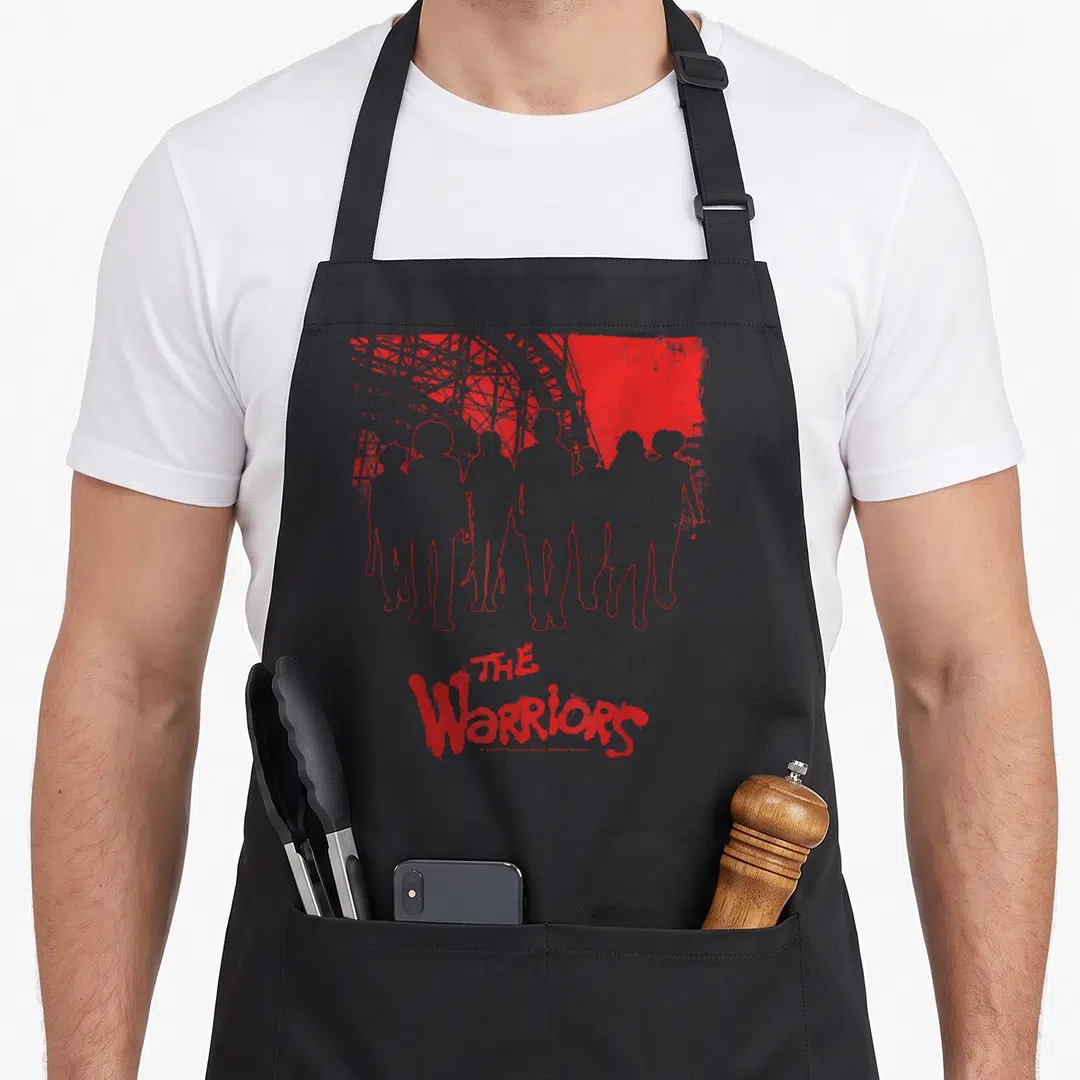 Warrior kitchen island apron - Seven grey silhouettes with red outline below red bridge structure and THE Warriors text — shown on a black cotton canvas apron against a white background