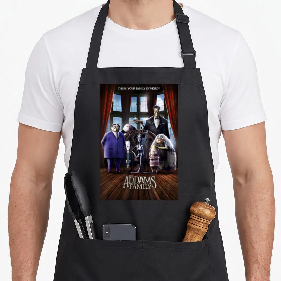 Shot personalized family aprons - Addams Family group photo with red curtains and wooden floor text — shown on a black cotton canvas apron against a white background