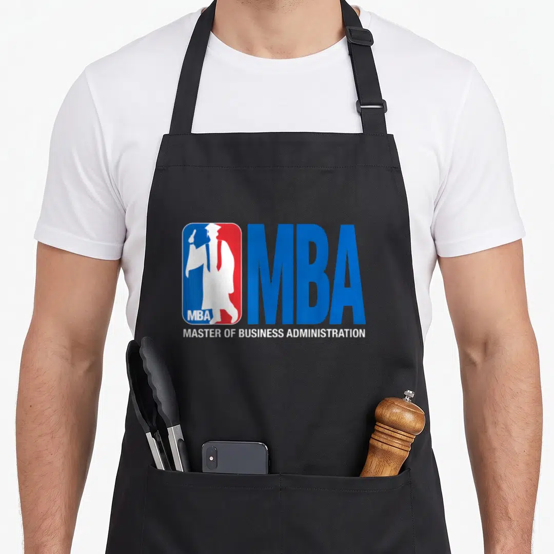 Basketball master apron - Blue red and white MBA logo with white graduate silhouette and degree name — shown on a black cotton canvas apron against a white background