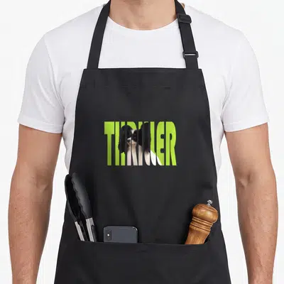 Thriller thrill apron - Lime green THRILLER text masking a black and white dog face — shown on a black cotton canvas apron against a white background