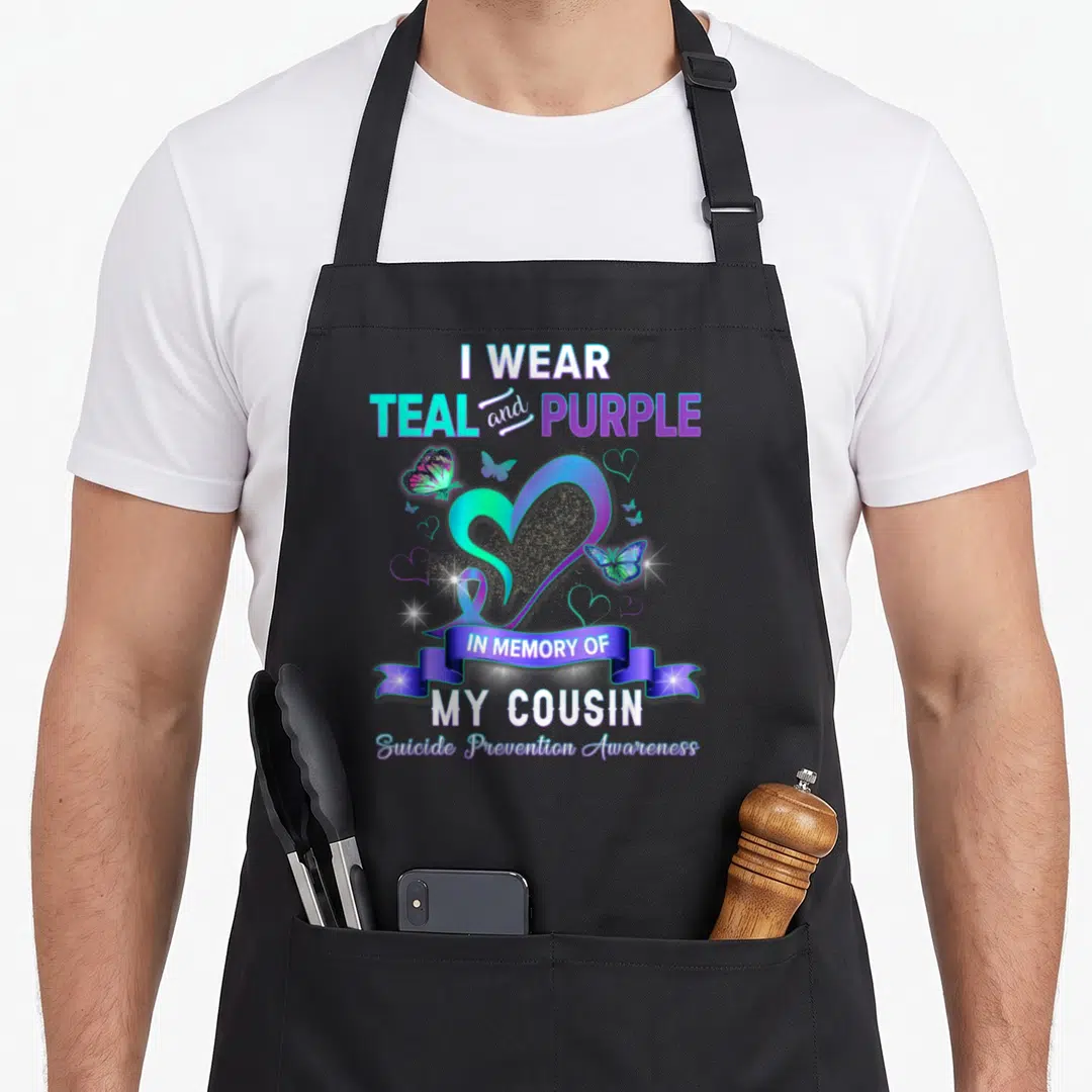 Cousin suicide prevention apron - Gradient heart with teal and purple butterflies and ribbon banner reading In Memory — shown on a black cotton canvas apron against a white background