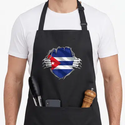 Pride hispanic aprons - Two hands tearing grey surface to reveal blue white and red Cuba flag — shown on a black cotton canvas apron against a white background