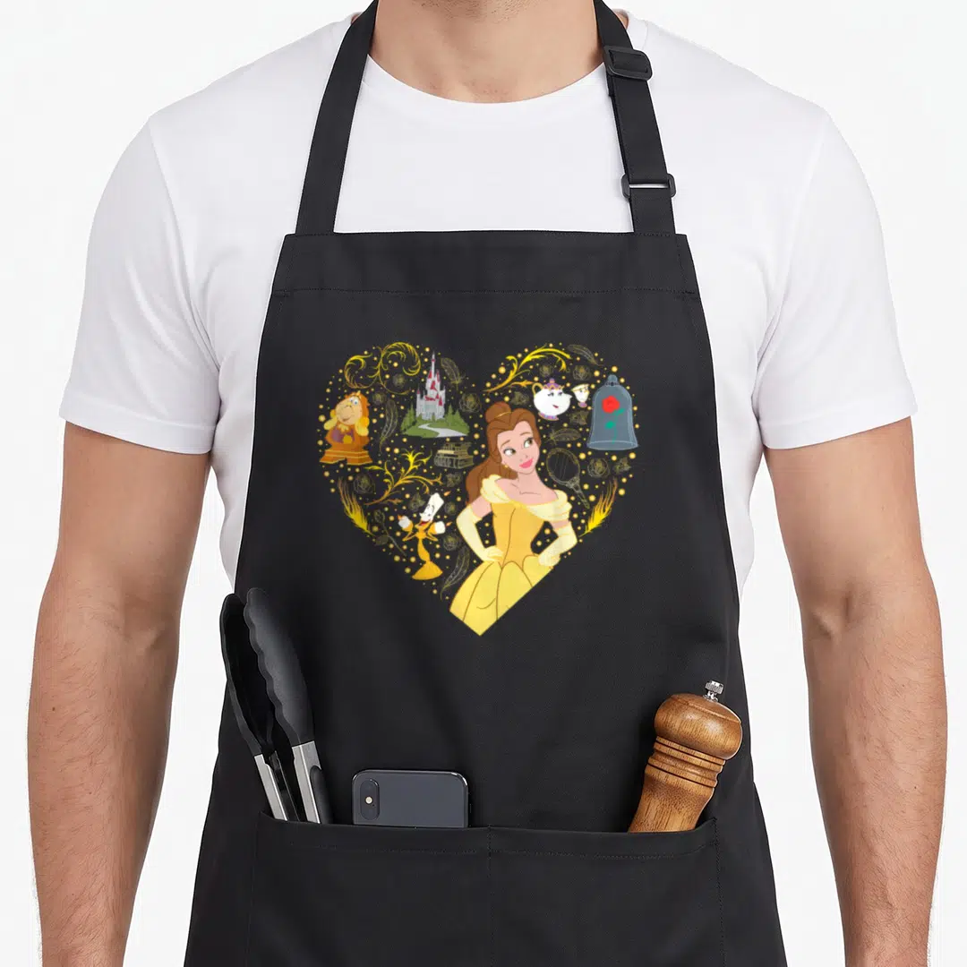 Collage princess apron - Belle and enchanted objects arranged in a heart shape with yellow and gold flourishes — shown on a black cotton canvas apron against a white background